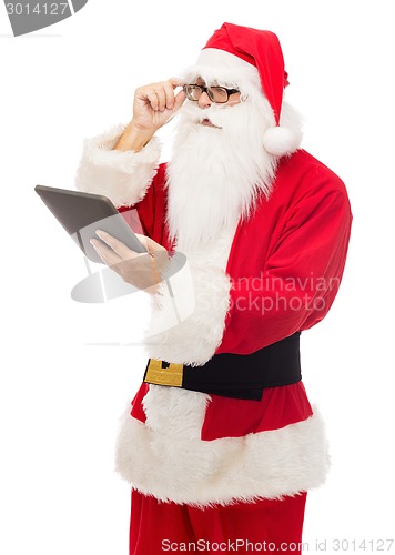 Image of man in costume of santa claus with tablet pc