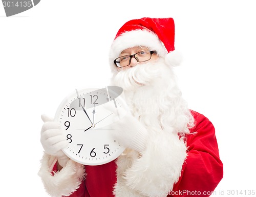 Image of man in costume of santa claus with clock