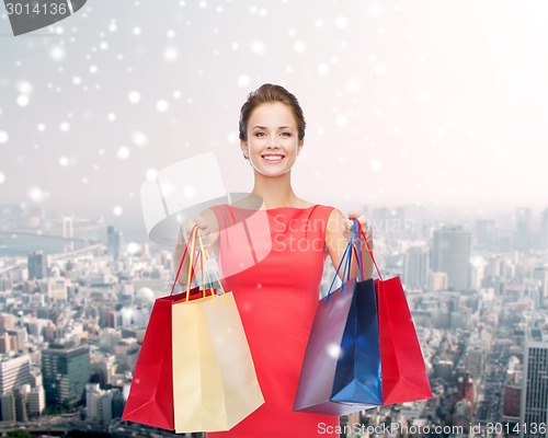 Image of smiling woman with colorful shopping bags