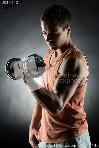 Image of young man with dumbbell