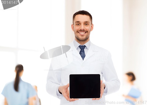 Image of smiling male doctor with tablet pc