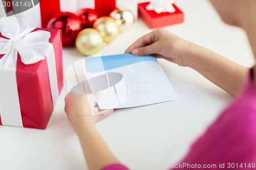 Image of close up of woman with letter and presents