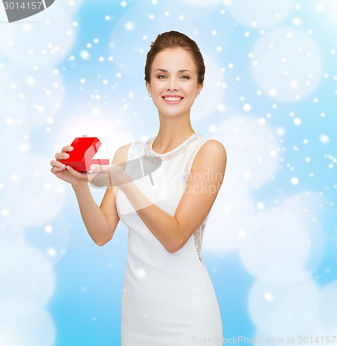 Image of smiling woman holding red gift box