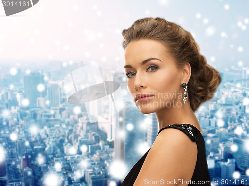 Image of beautiful woman in evening dress wearing earrings