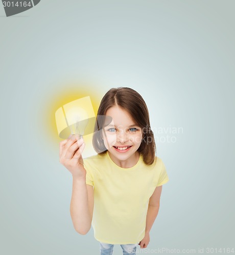 Image of smiling little girl holding light bulb