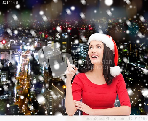 Image of smiling woman in santa helper hat