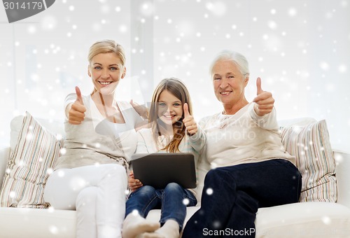 Image of smiling family with tablet pc at home