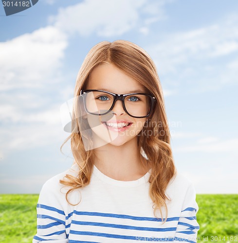 Image of smiling cute little girl with black eyeglasses