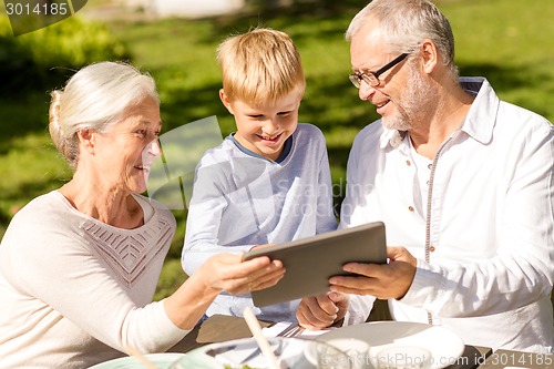 Image of happy family with tablet pc outdoors