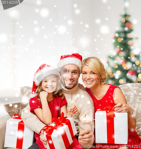 Image of smiling family holding many gift boxes