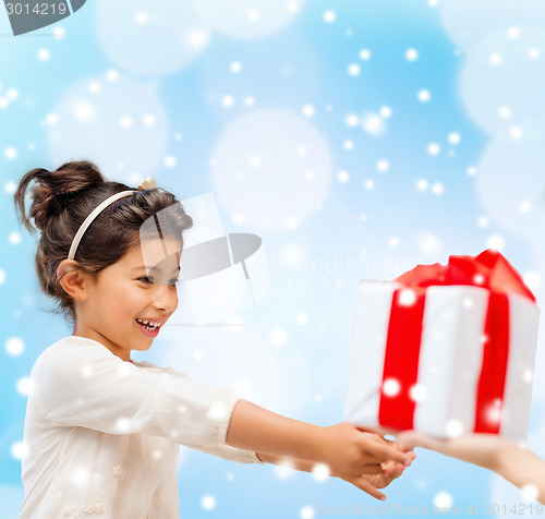 Image of smiling little girl with gift box