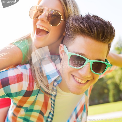 Image of smiling couple having fun in park