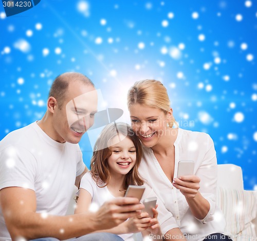 Image of happy family with smartphones