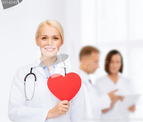 Image of smiling female doctor with heart and stethoscope