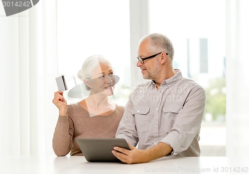 Image of happy senior couple with tablet pc and credit card