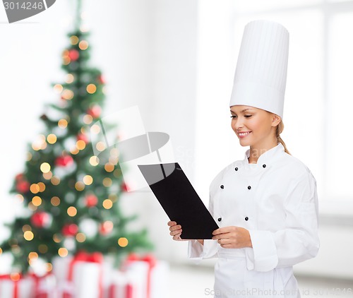 Image of smiling female chef with black blank paper