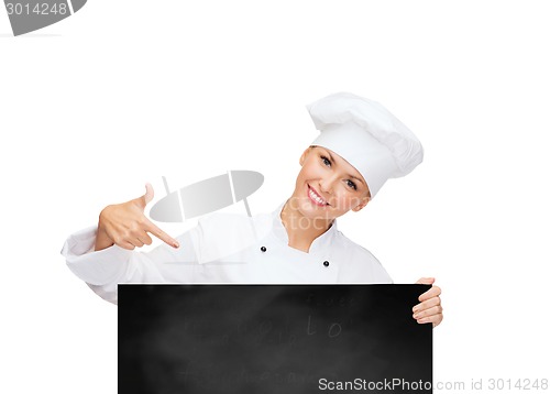 Image of smiling female chef with white blank board