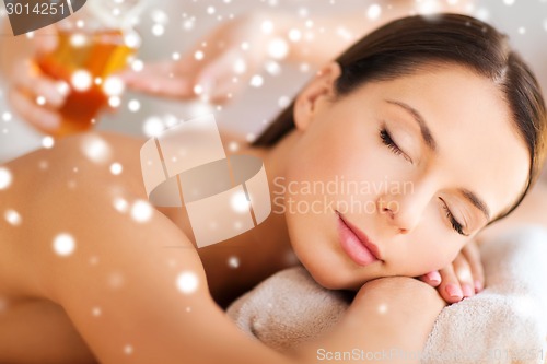 Image of beautiful young woman in spa salon getting massage