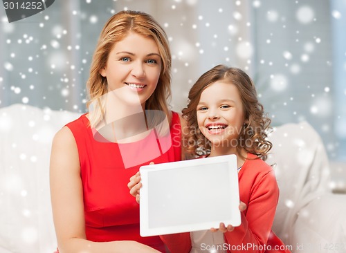 Image of mother and daughter with tablet pc at home