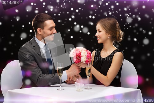 Image of smiling couple course at restaurant