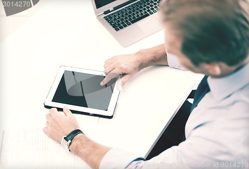 Image of businessman with tablet pc in office