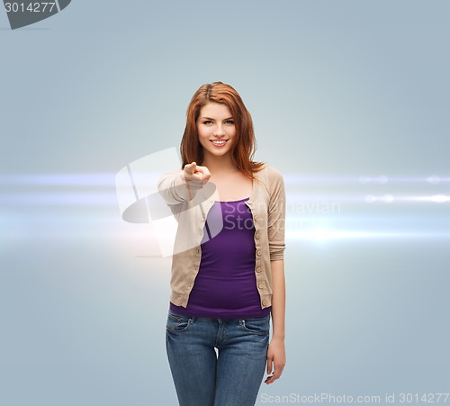 Image of smiling teenage girl pointing finger at you
