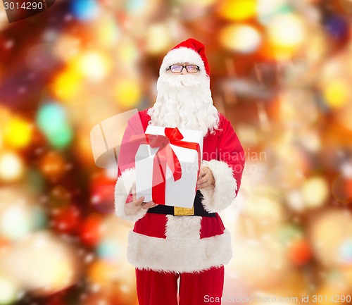 Image of man in costume of santa claus with gift box