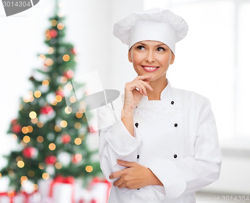 Image of smiling female chef dreaming