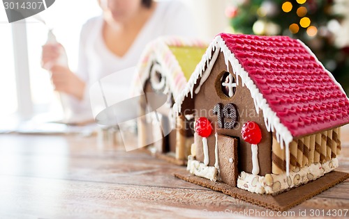 Image of close up of woman making gingerbread houses