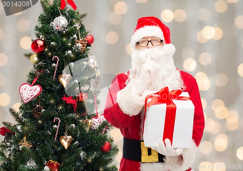 Image of man in costume of santa claus with gift box