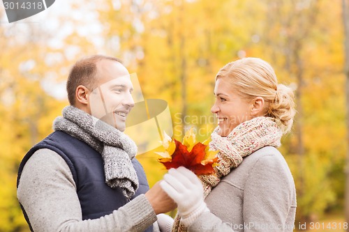 Image of smiling couple in autumn park