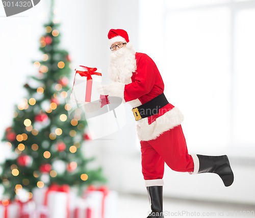 Image of man in costume of santa claus with gift box