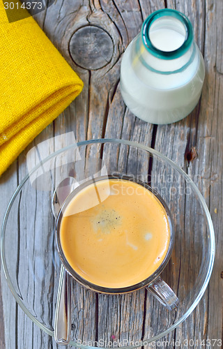 Image of Cup of espresso and milk on old wood