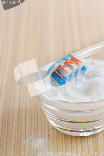 Image of sodium bicarbonate  and a toothbrush