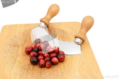 Image of Whole fresh cranberries with a rocking knife