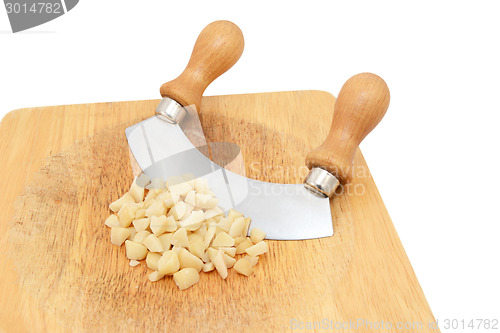 Image of Coarsely chopped macadamia nuts with a rocking knife