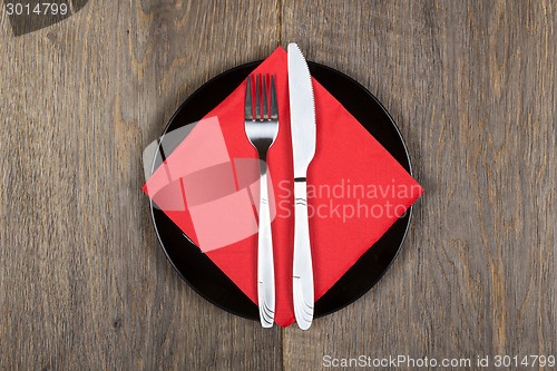 Image of Plate, knfie and fork on a napkin.