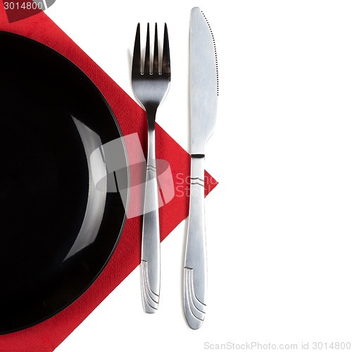 Image of Plate, knfie and fork on a napkin.