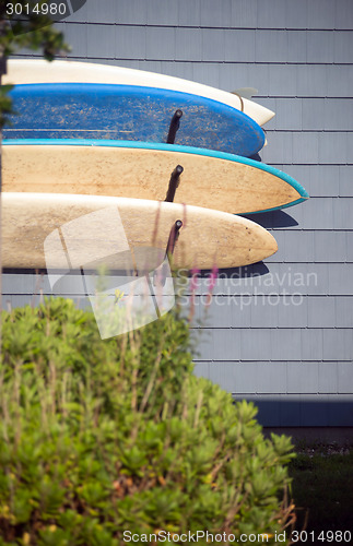 Image of worn surfboards hanging from house Montauk, New York, USA