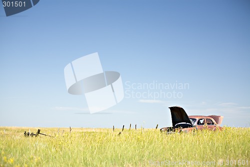 Image of abandoned car in field