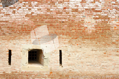 Image of window on ancient brick wall