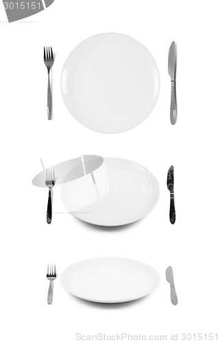 Image of White plate with fork and knife.