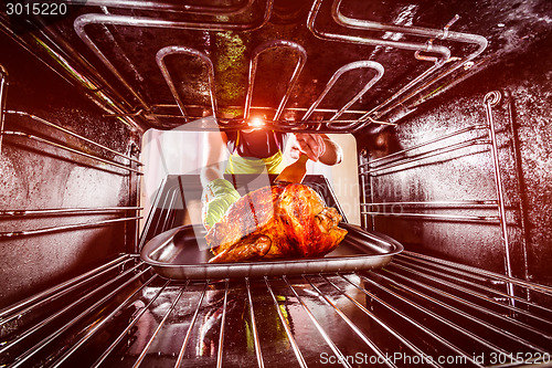 Image of Cooking chicken in the oven at home.