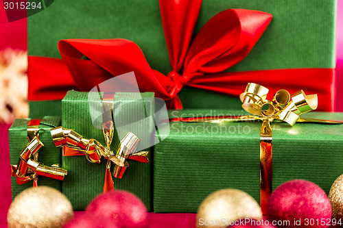 Image of Four Xmas Presents with Bows in Gold and Red