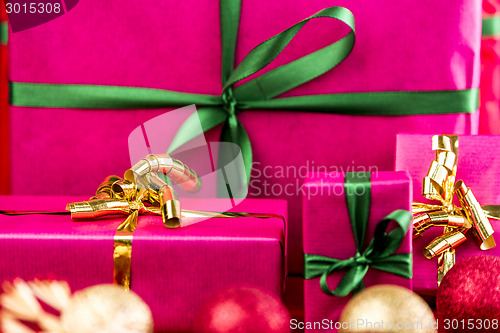 Image of Four Xmas Presents Wrapped in Plain Magenta