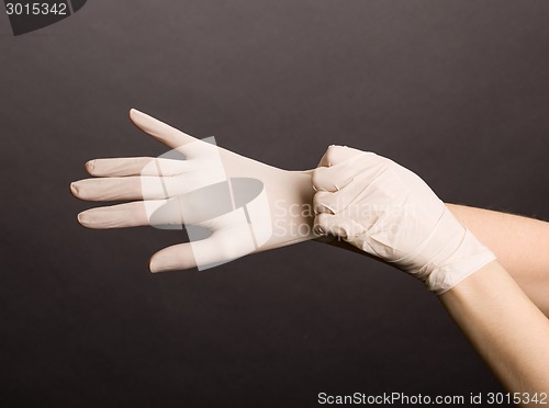 Image of Putting on latex gloves