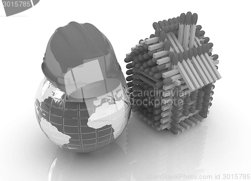 Image of Log house from matches pattern and hard hat on earth 