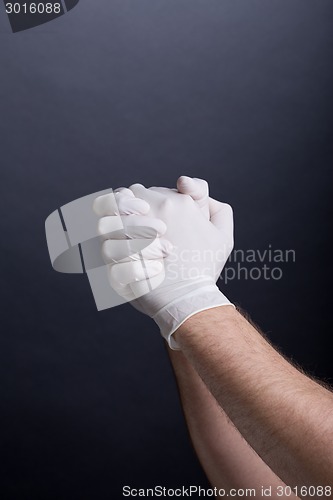 Image of Male hands in latex gloves