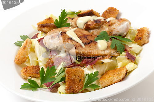 Image of Chicken caesar salad, side view