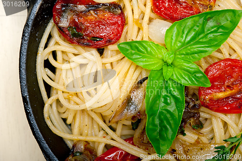 Image of spaghetti pasta with baked cherry tomatoes and basil 